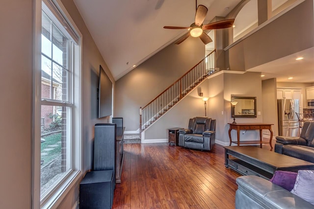 living room with baseboards, a healthy amount of sunlight, stairway, and hardwood / wood-style floors