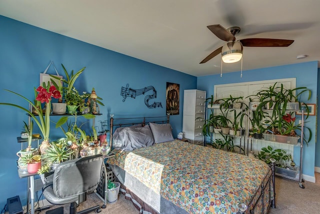 carpeted bedroom featuring a ceiling fan and baseboards