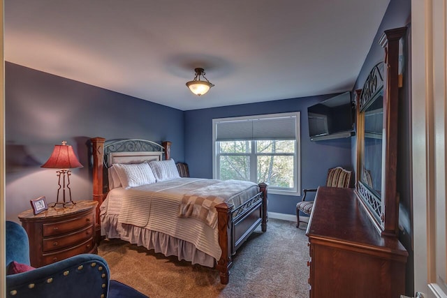 bedroom with carpet flooring and baseboards