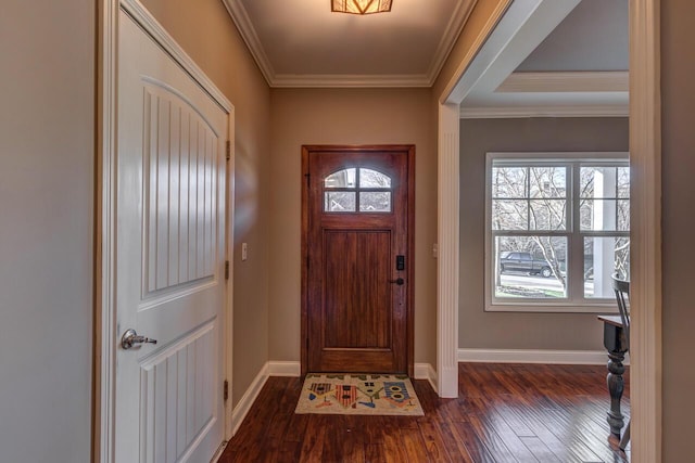 foyer with dark wood-style floors, crown molding, and baseboards