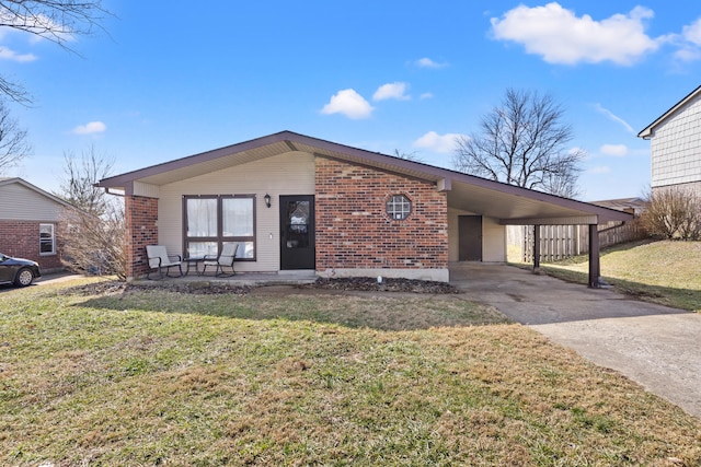 view of front facade with a carport, concrete driveway, brick siding, and a front lawn