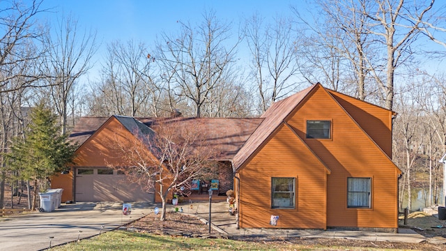 view of side of property featuring a garage and a chimney