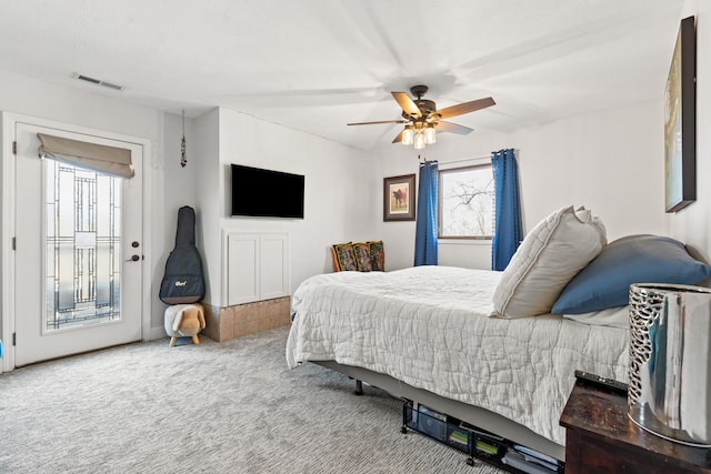 bedroom with a ceiling fan, carpet flooring, visible vents, and access to exterior