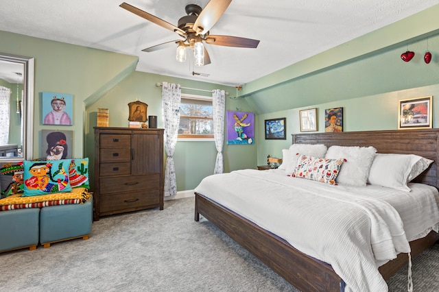 bedroom featuring lofted ceiling, light colored carpet, visible vents, a ceiling fan, and baseboards