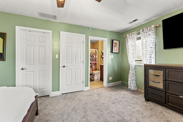 bedroom featuring light carpet, baseboards, and visible vents