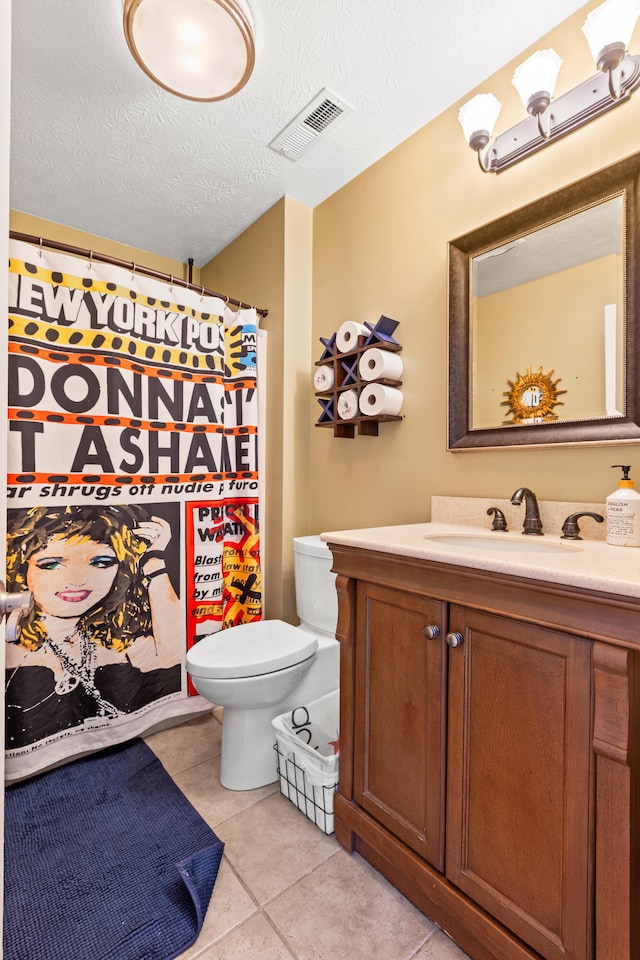 bathroom featuring visible vents, toilet, tile patterned floors, a textured ceiling, and vanity