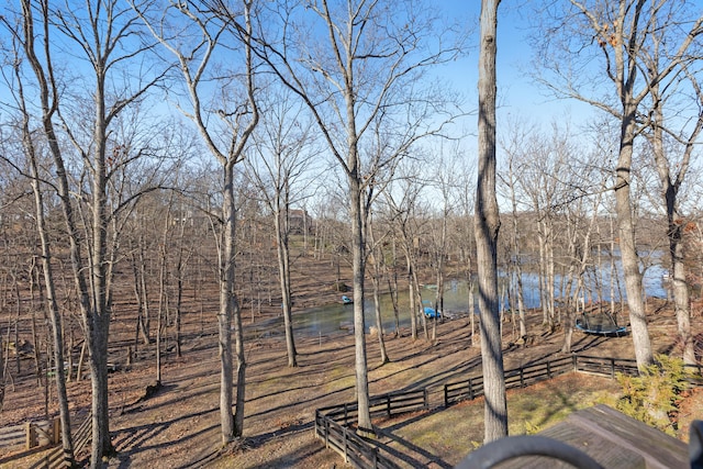 view of yard featuring a water view and fence