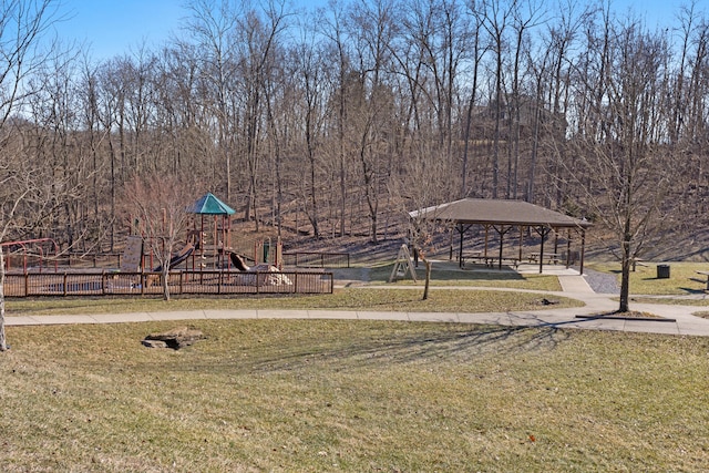 communal playground featuring a yard, a gazebo, and fence