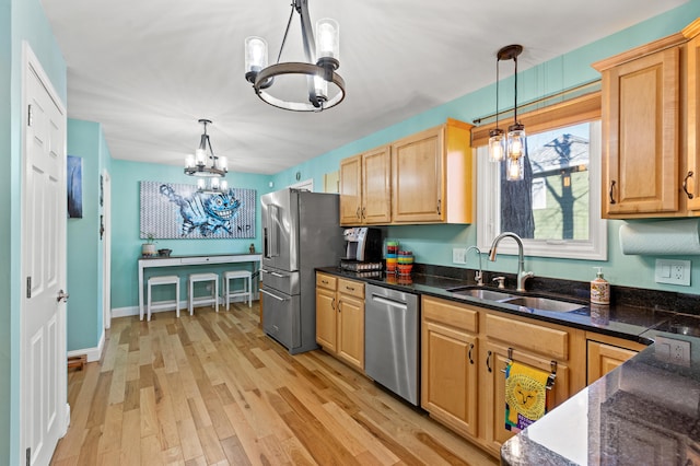 kitchen featuring a chandelier, stainless steel appliances, decorative light fixtures, and dark countertops