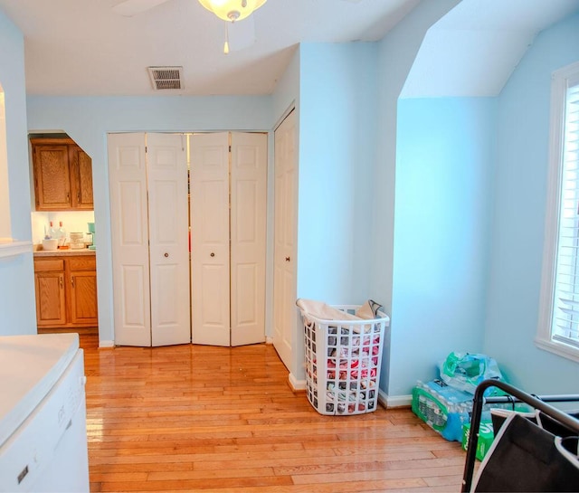 bedroom with visible vents, a closet, light wood-style flooring, and baseboards