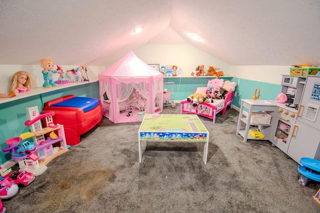 playroom featuring carpet, vaulted ceiling, and a textured ceiling