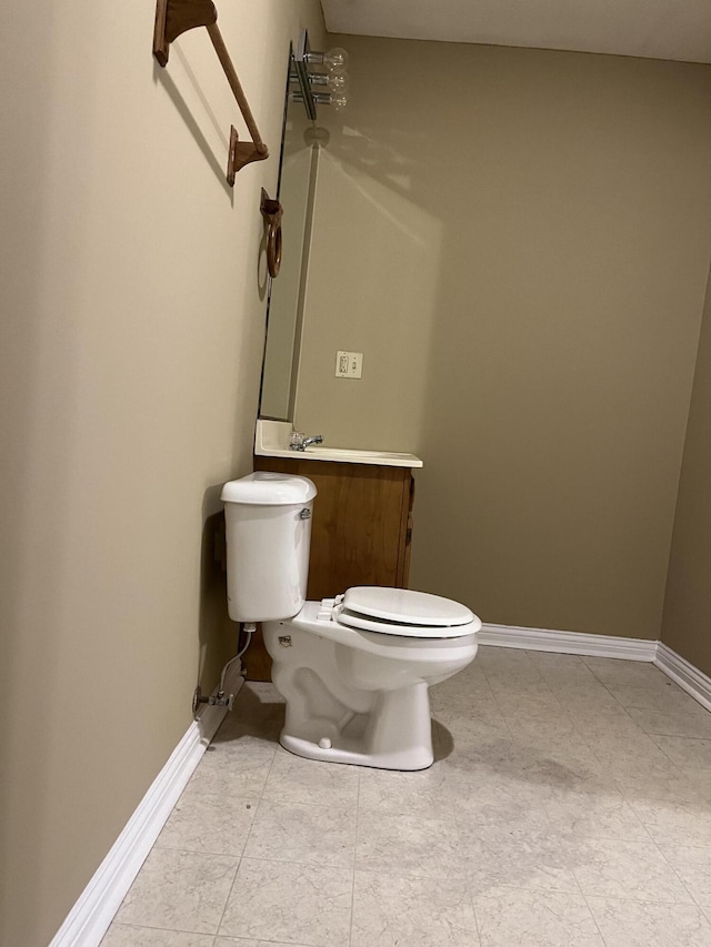 bathroom featuring toilet and baseboards