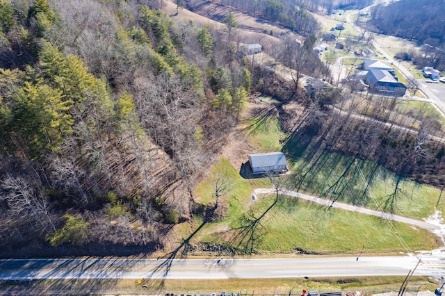 birds eye view of property with a wooded view