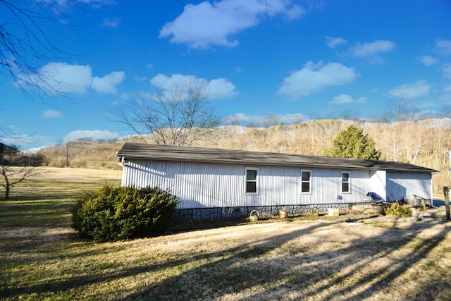 view of side of home featuring crawl space and a yard