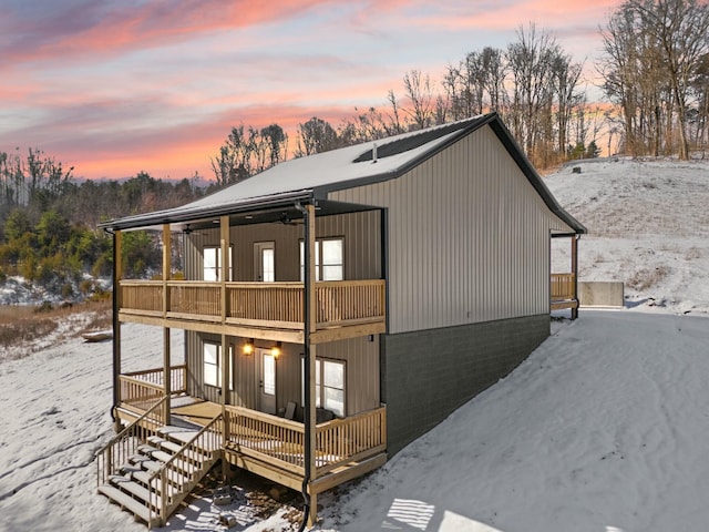 exterior space with a porch, a balcony, and stairs