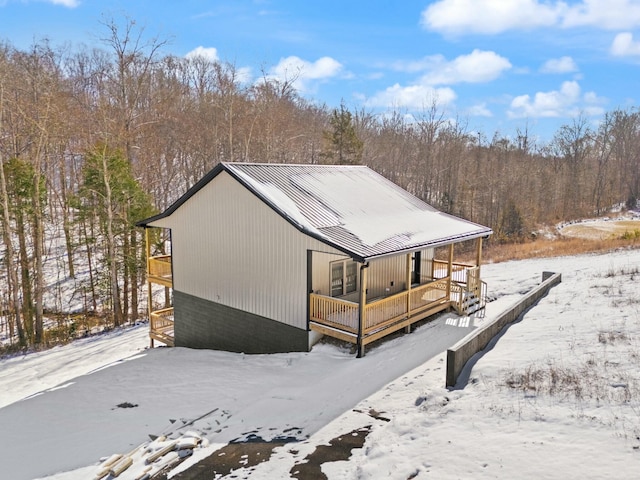 exterior space featuring metal roof and a porch