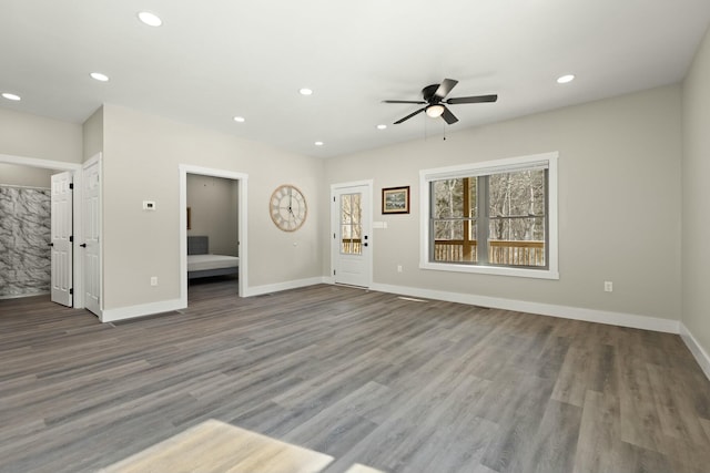 unfurnished living room with a ceiling fan, baseboards, dark wood-style flooring, and recessed lighting