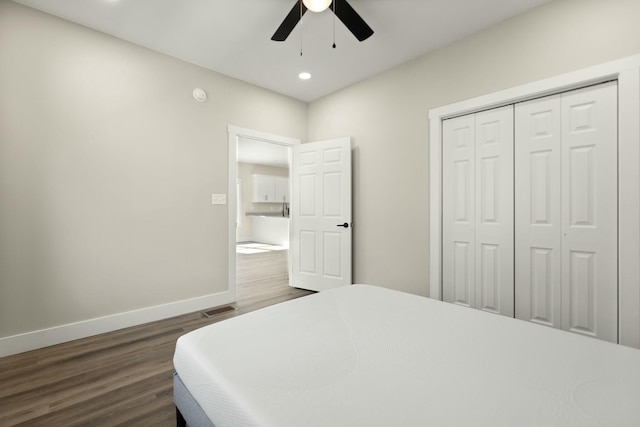 bedroom with baseboards, dark wood finished floors, a ceiling fan, a closet, and recessed lighting