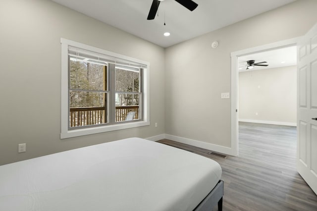 bedroom featuring recessed lighting, wood finished floors, visible vents, and baseboards