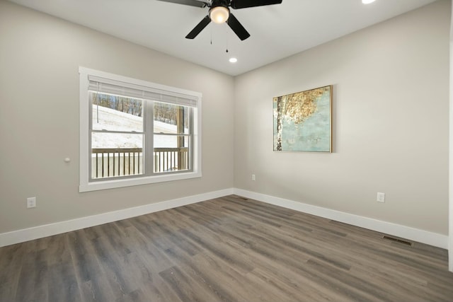 spare room with recessed lighting, dark wood-style flooring, a ceiling fan, visible vents, and baseboards