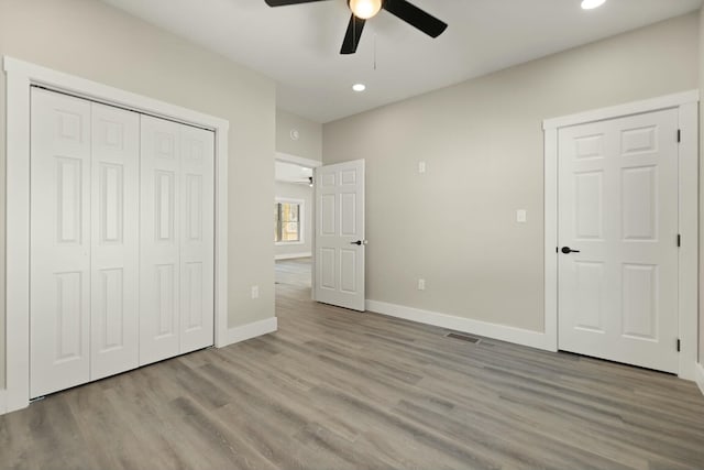 unfurnished bedroom featuring light wood finished floors, recessed lighting, a closet, a ceiling fan, and baseboards