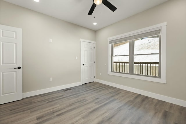 spare room featuring baseboards, visible vents, ceiling fan, wood finished floors, and recessed lighting