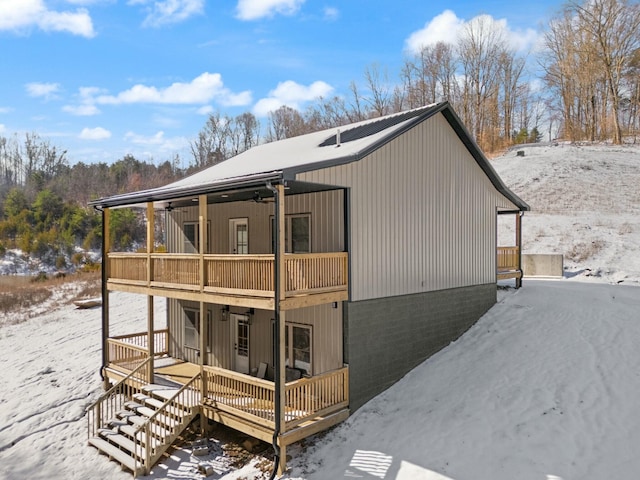 exterior space featuring a balcony, stairway, and a porch