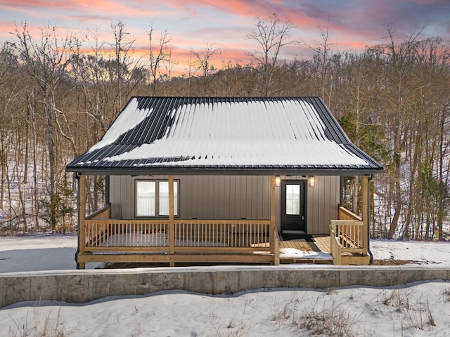 chalet / cabin with covered porch and metal roof