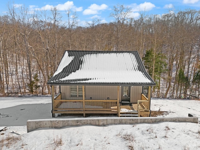 chalet / cabin with covered porch and metal roof