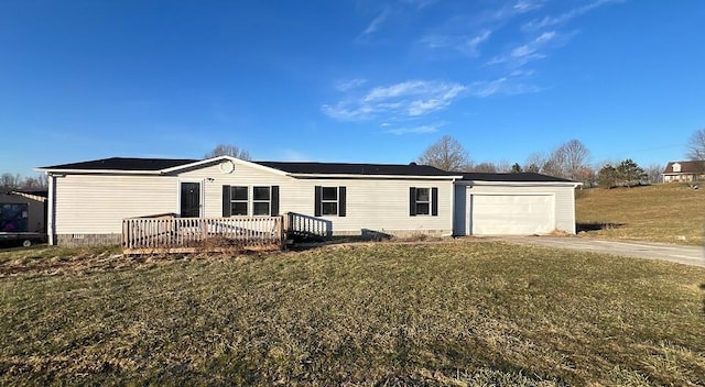 view of front of home with driveway, an attached garage, a front lawn, and a deck