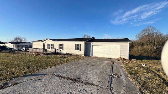 view of front facade with a garage, a residential view, driveway, and a front lawn