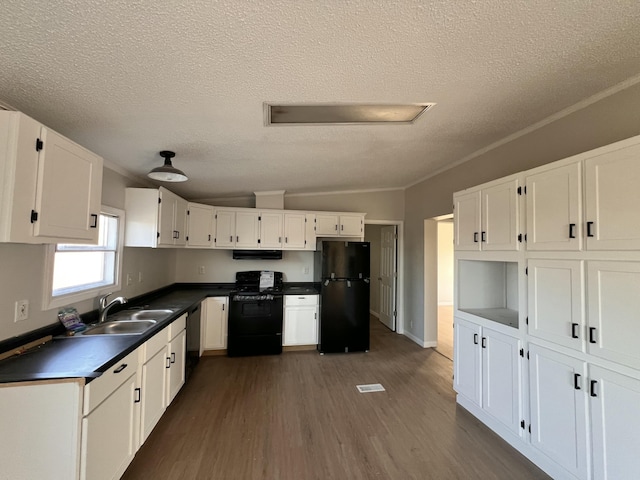 kitchen with dark countertops, white cabinets, and black appliances