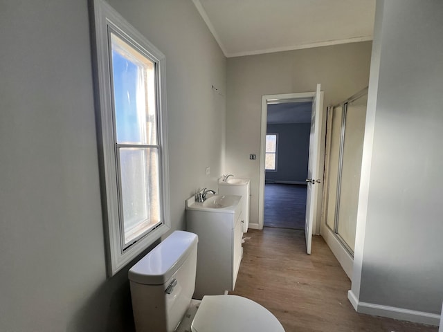 full bath featuring ornamental molding, wood finished floors, vanity, and a shower stall