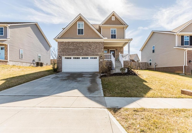 craftsman house with driveway, brick siding, an attached garage, and a front yard