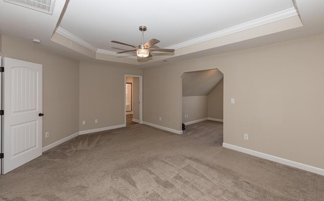 interior space with ornamental molding, carpet, a raised ceiling, and visible vents