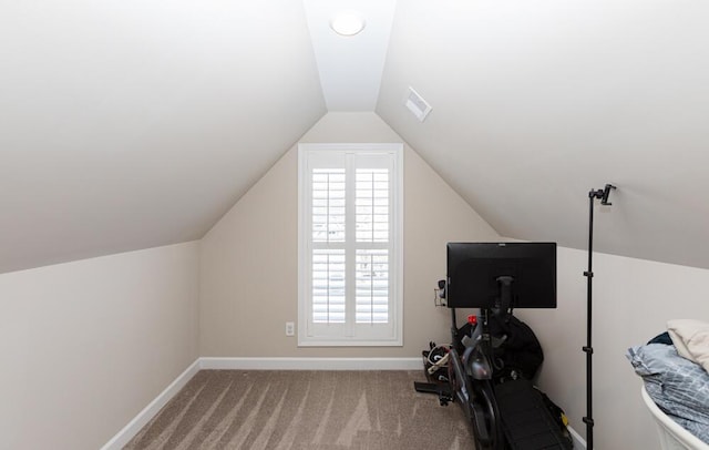 workout area featuring lofted ceiling, carpet, visible vents, and baseboards