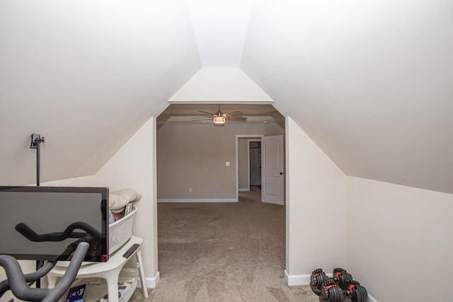 office with a ceiling fan, light colored carpet, vaulted ceiling, and baseboards