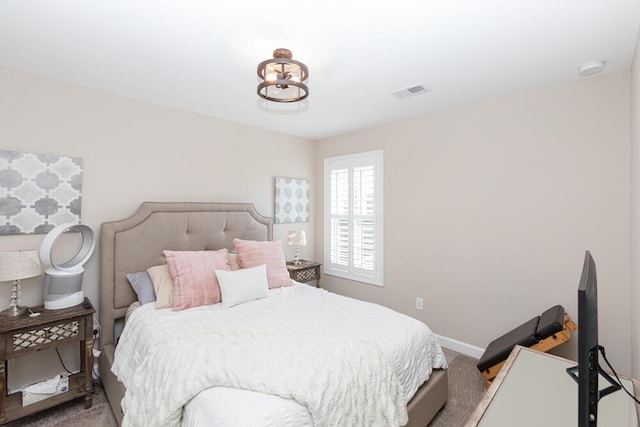 bedroom with carpet floors, visible vents, and baseboards