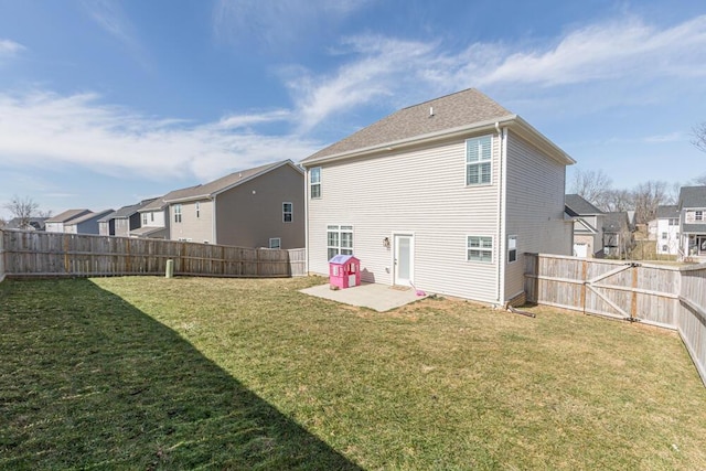 back of house featuring a lawn, a patio area, a fenced backyard, and a residential view