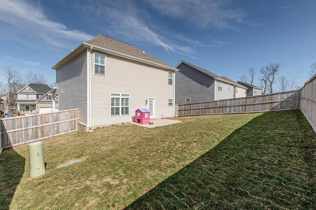 back of property featuring a fenced backyard, a yard, and a patio