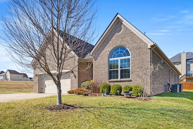 view of front of property with a front lawn, concrete driveway, and brick siding