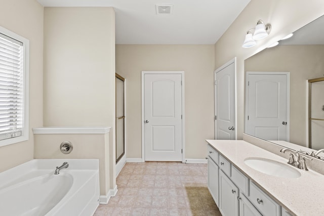 bathroom with a stall shower, baseboards, visible vents, vanity, and a bath