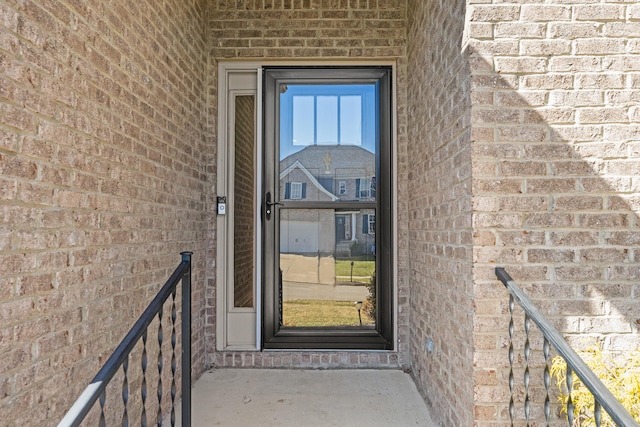 view of exterior entry with brick siding