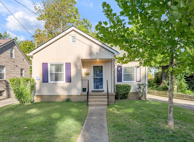 bungalow-style home with a front yard