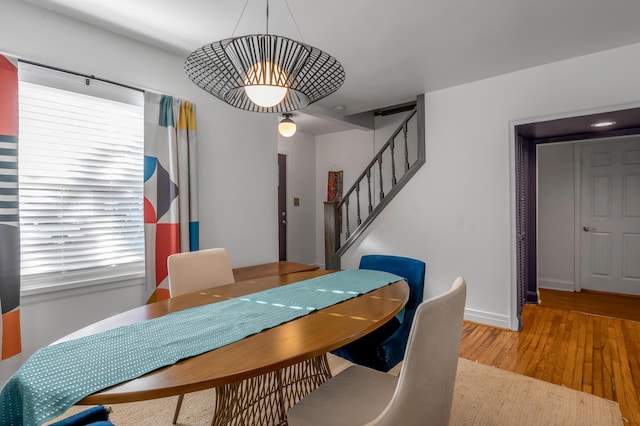 dining room with stairway, wood finished floors, and baseboards