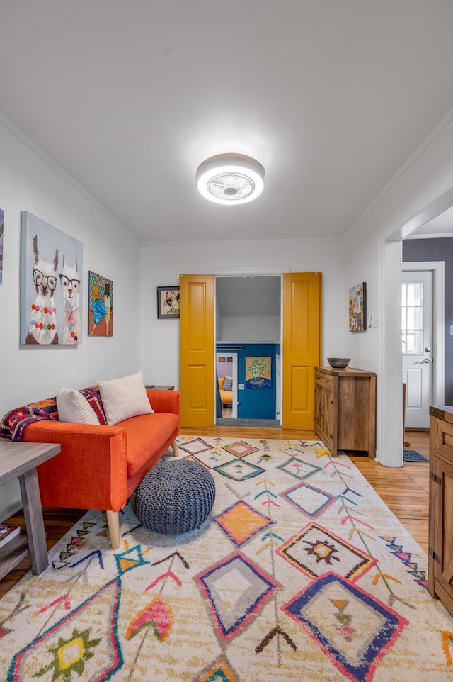 living room with crown molding and light wood-style flooring