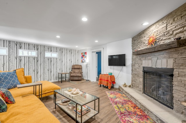 living room with recessed lighting, a fireplace, baseboards, and wood finished floors