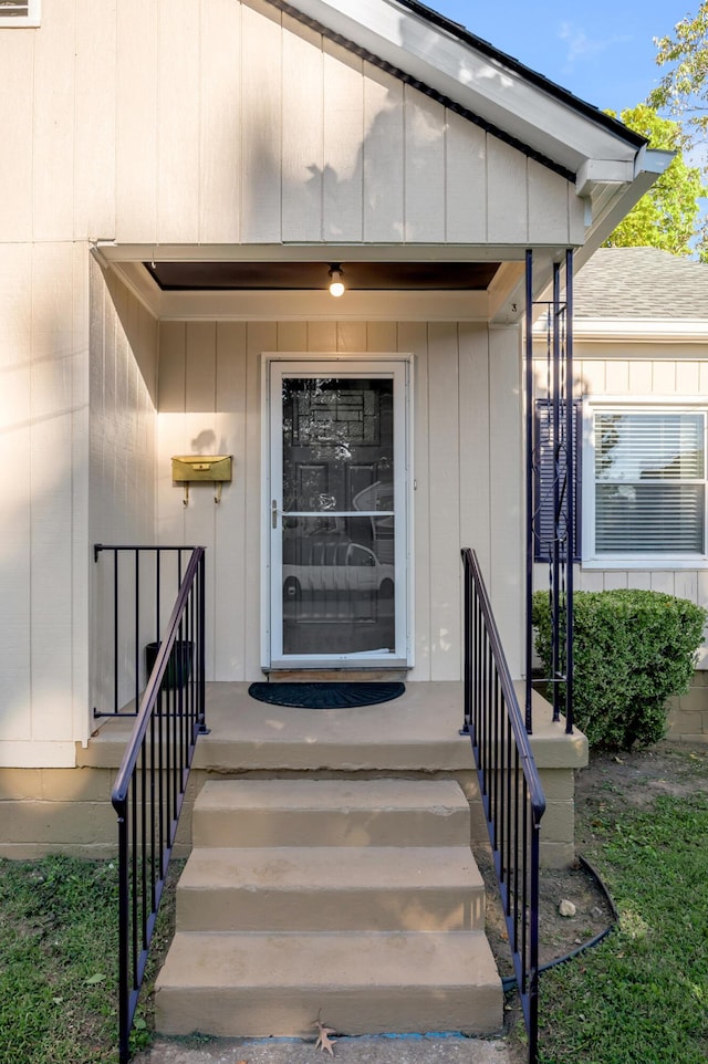 entrance to property with roof with shingles