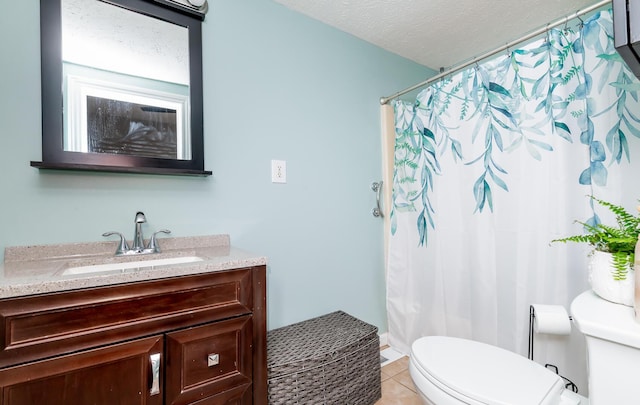 full bath featuring toilet, curtained shower, tile patterned flooring, a textured ceiling, and vanity