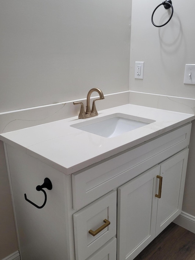 bathroom with wood finished floors and vanity